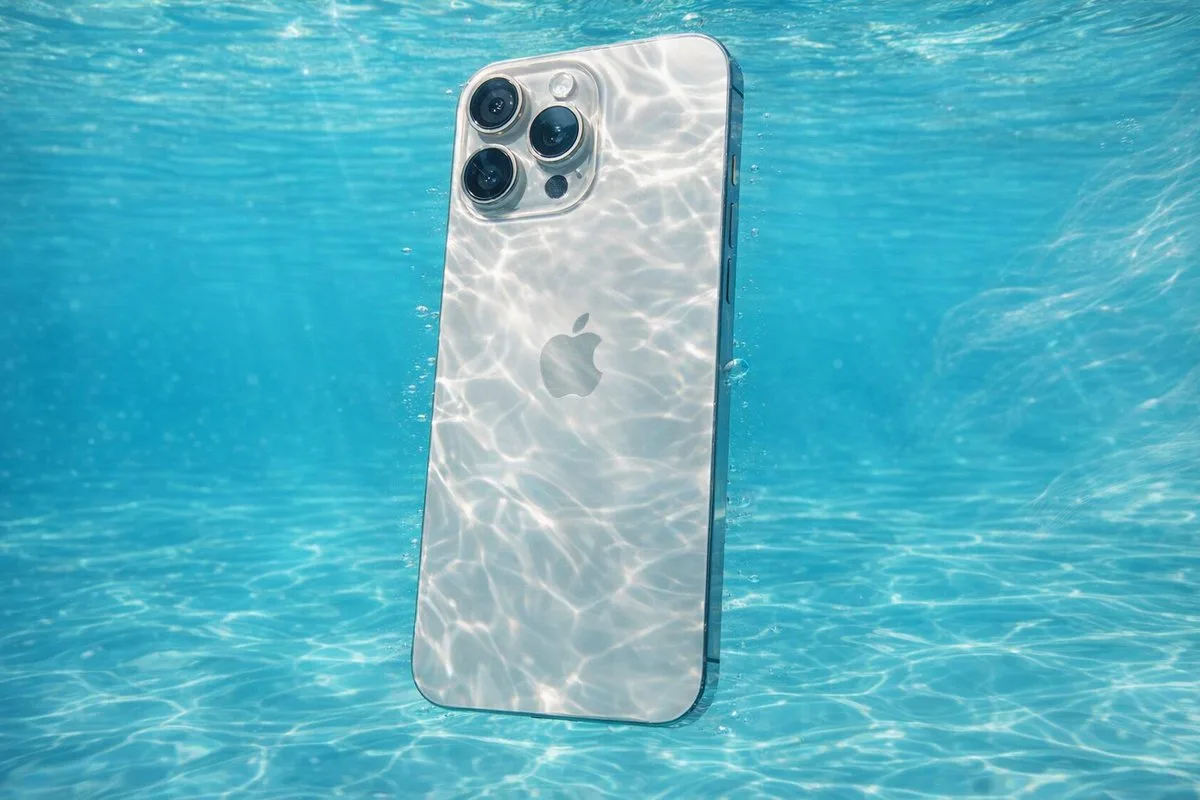 A serene underwater photograph of a subject submerged in crystal-clear turquoise water with caustic sunlight patterns.