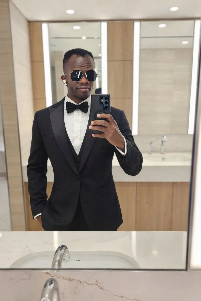 A man wearing a formal black tuxedo and bow tie. (2)