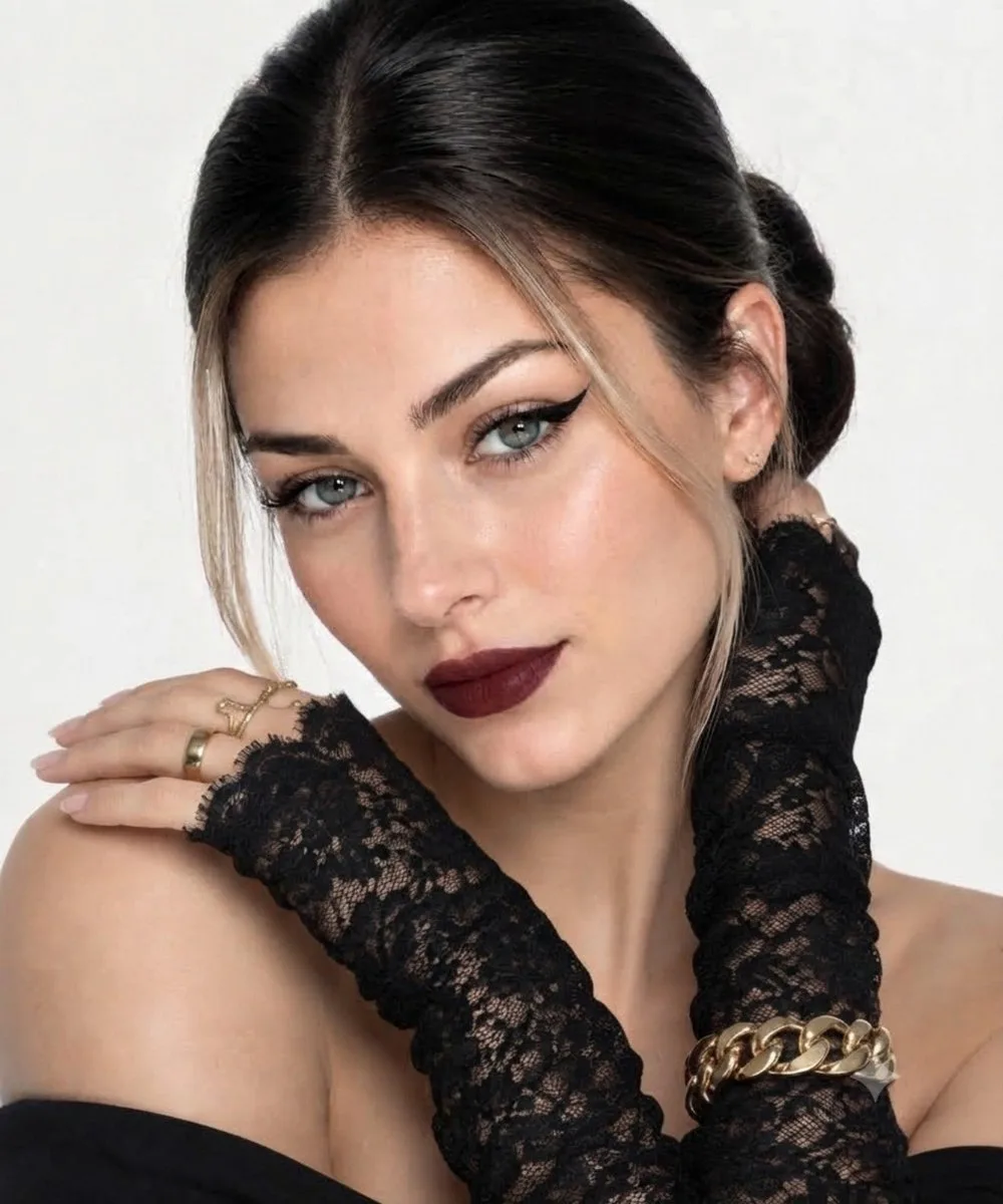 Elegant fashion portrait of a woman with dark hair, burgundy lips, and gold jewelry.