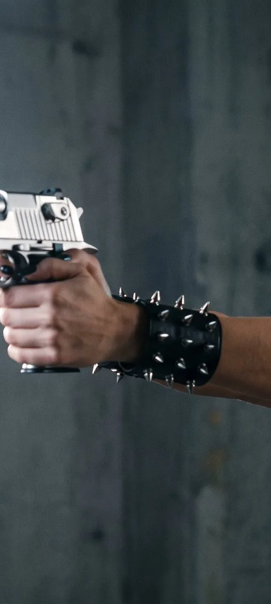 90s action heroine with platinum blonde hair aiming a pistol in an industrial setting. (2)