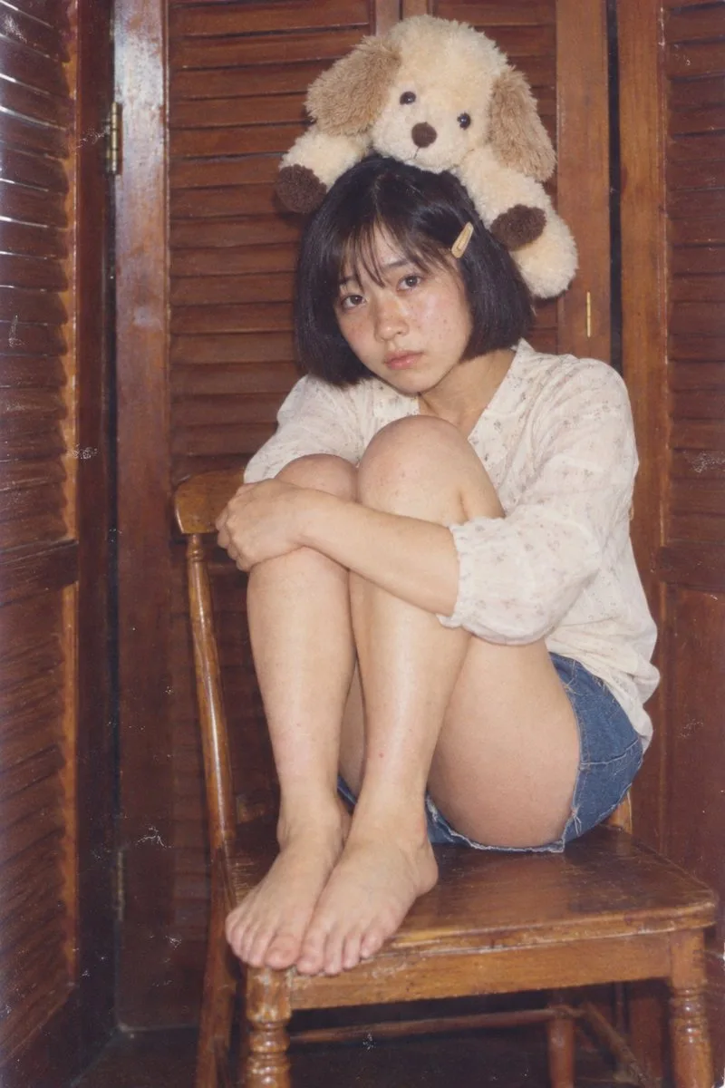 Retro photograph of a melancholic young woman with a plush dog on her head