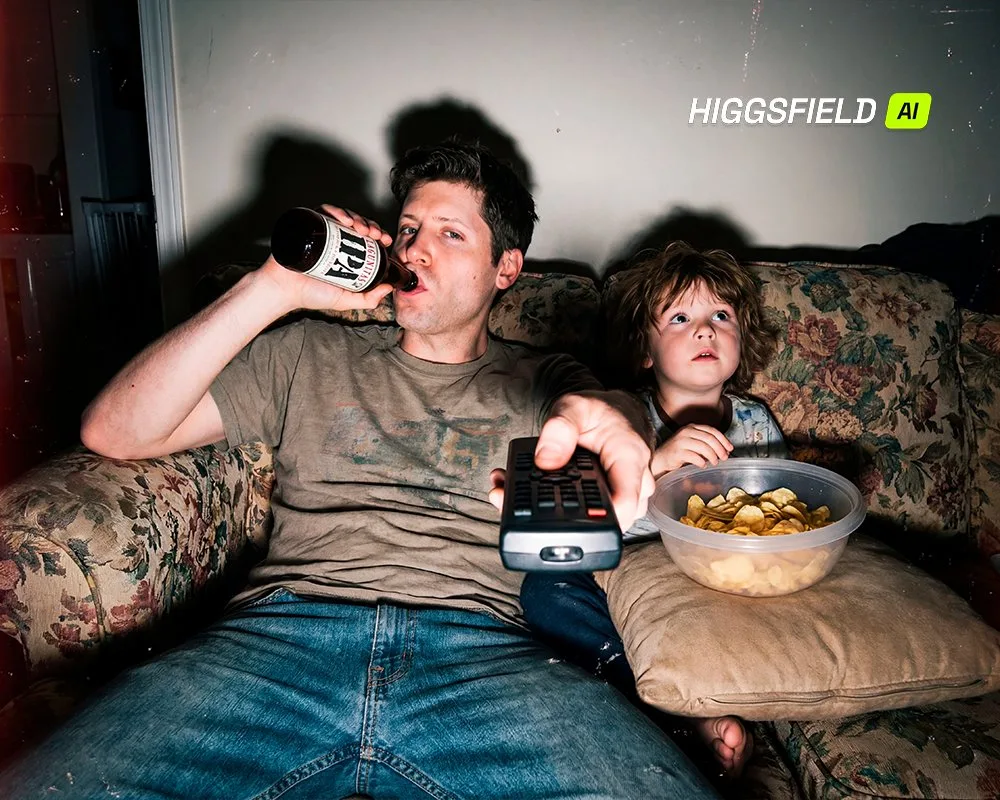 A tired father and child sitting on a vintage couch at night.